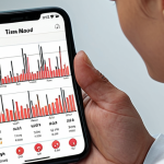 **A person using a mobile app to track their mood and activities, showing a graph or chart of mood fluctuations over time.** (Focus: Technology & Mood Tracking)
